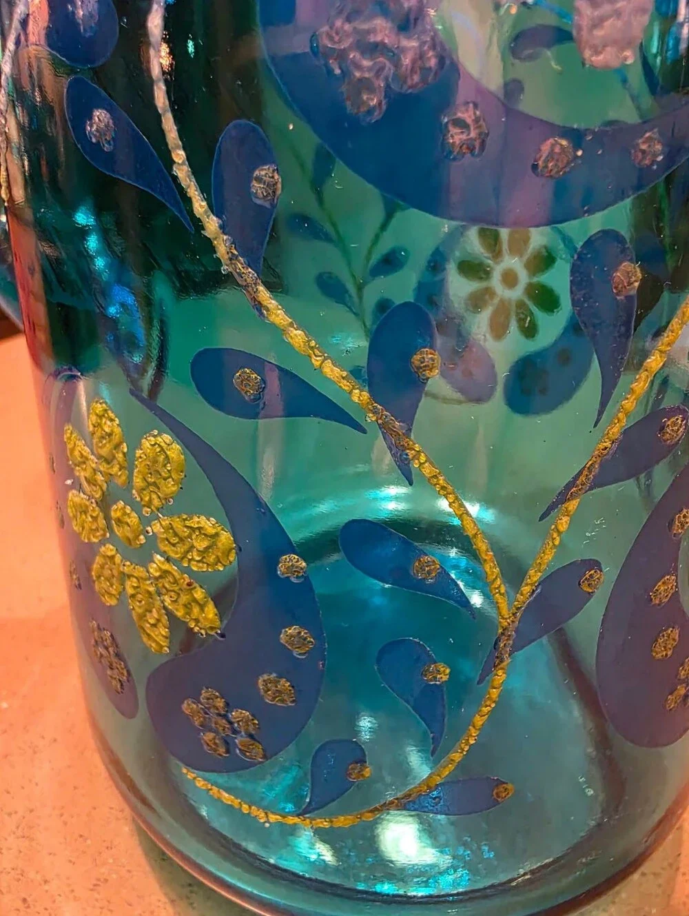 Vintage turquoise Libbey glass pitcher with painted design.